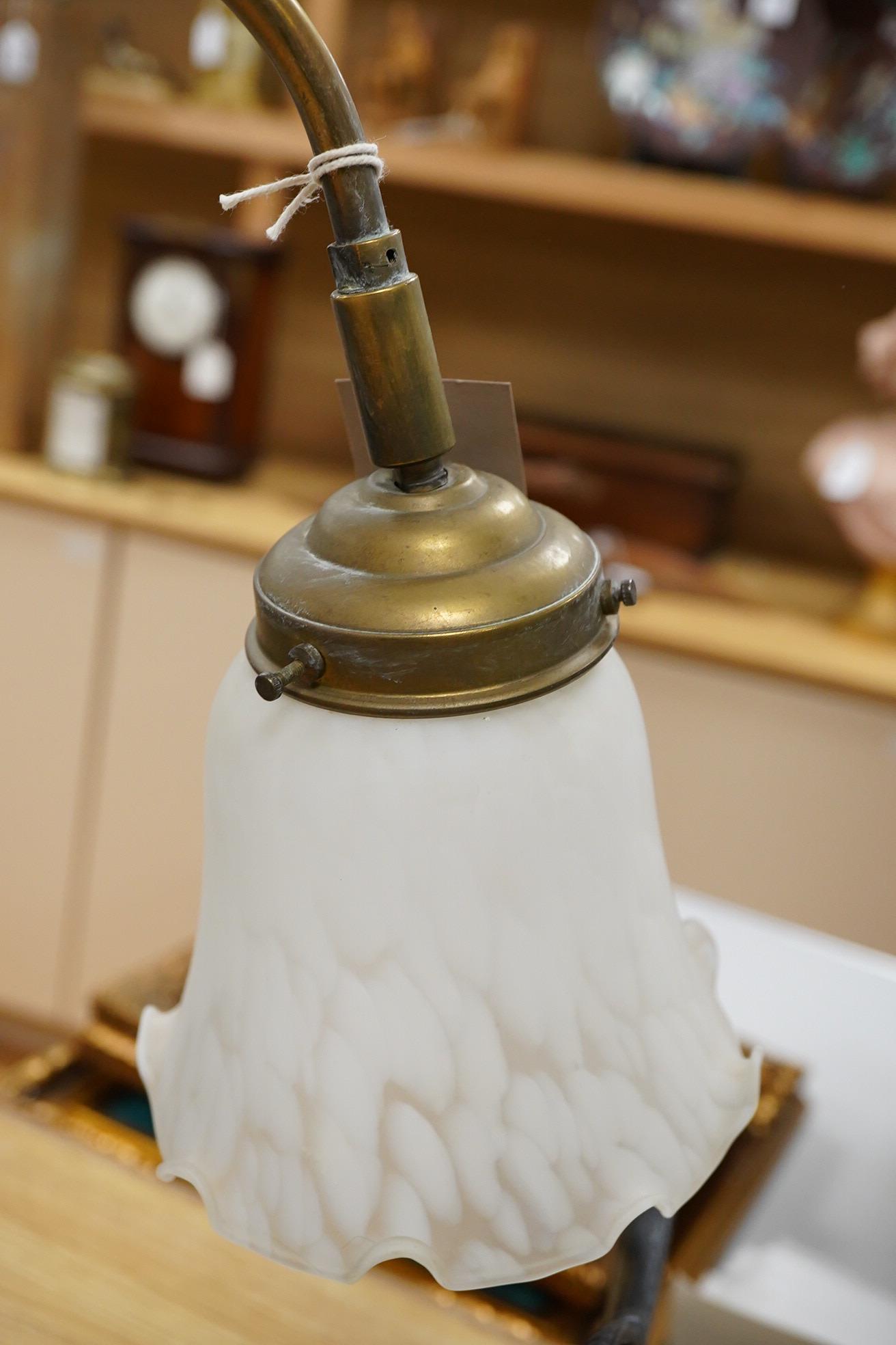 A brass rise and fall table lamp with opaque glass shades, 60cm high when extended